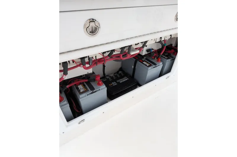 Slide: The Image of 2026 Caymas 30 CT boat battery compartment with multiple batteries and wiring. - 11
