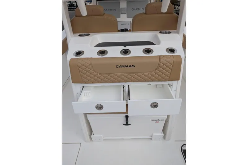 Slide: The Image of 2026 Caymas 30 CT boat interior with tan upholstery and storage compartments. - 12