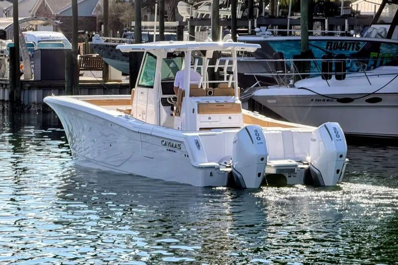 Slide: The Image of 2026 Caymas 30 CT boat with dual engines docked in a marina. - 3