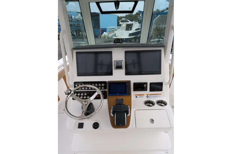 Slide: The Image of 2026 Caymas 30 CT boat dashboard with modern controls and dual screens. - 4