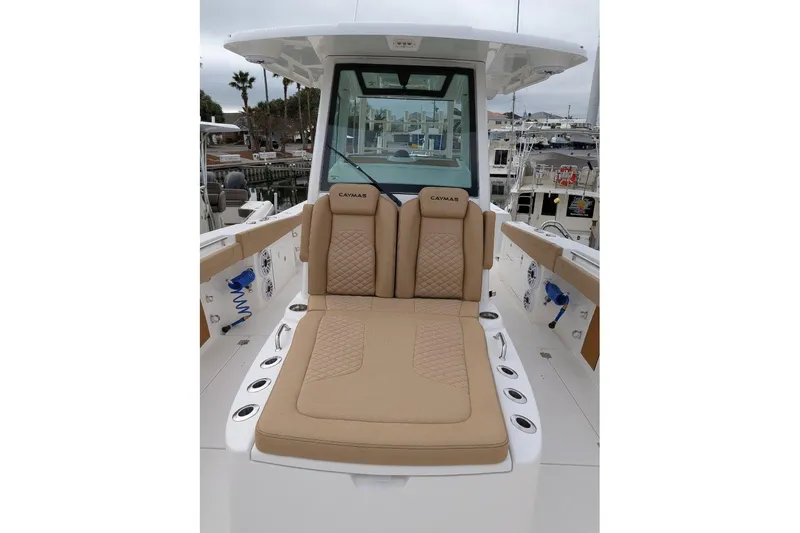 Slide: The Image of 2026 Caymas 30 CT boat interior with tan cushioned seating and modern design. - 6