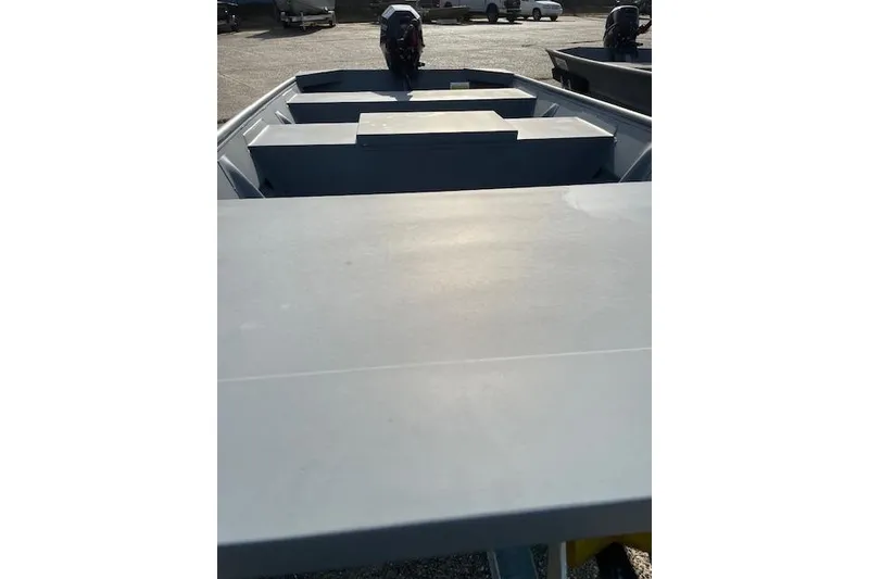 Slide: The Image of 2024 Southfork 1242 boat interior with motor, parked outdoors. - 7