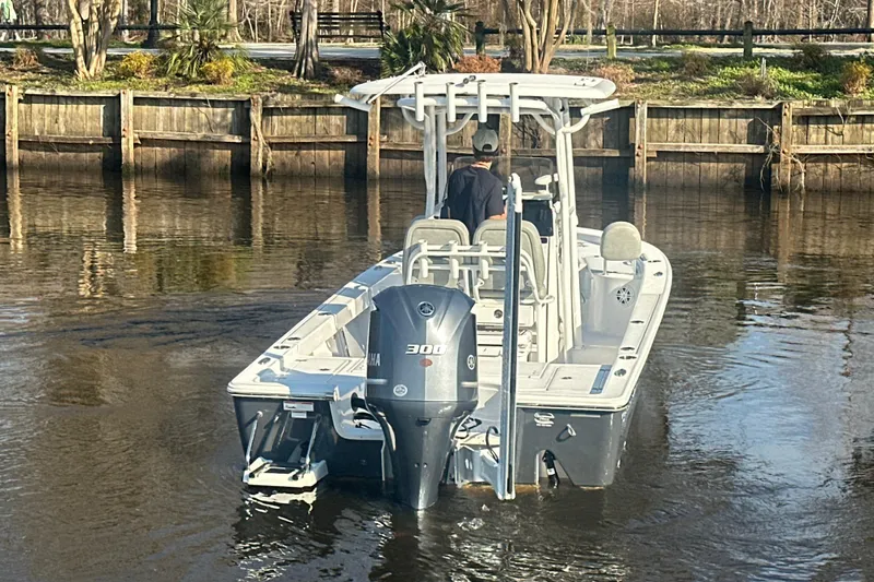 Slide: The Image of 2020 Sportsman Masters 247 Bay Boat on calm water near a wooden dock. - 10
