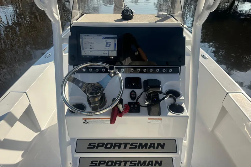 Slide: The Image of 2020 Sportsman Masters 247 Bay Boat dashboard with steering wheel and navigation controls. - 13