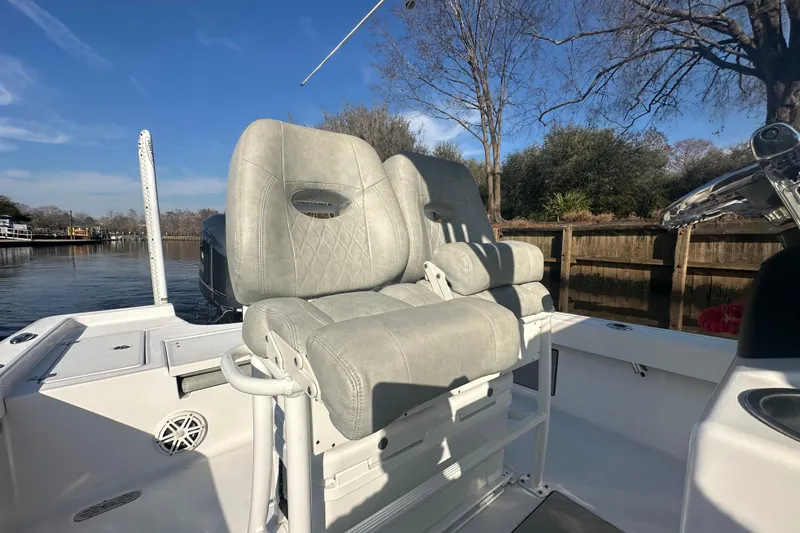 Slide: The Image of 2020 Sportsman Masters 247 Bay Boat interior with comfortable seating and scenic waterway view. - 16
