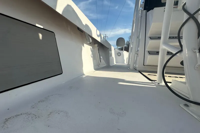 Slide: The Image of 2020 Sportsman Masters 247 Bay Boat interior, showcasing deck and seating area under clear sky. - 23