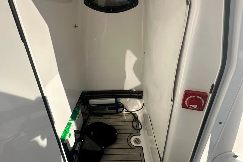 Slide: The Image of Interior view of a 2020 Sportsman Masters 247 Bay Boat, featuring storage and electrical components. - 32