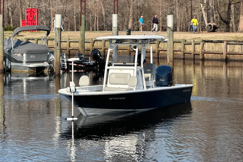 Slide: The Image of 2020 Sportsman Masters 247 Bay Boat docked in a serene marina setting. - 4