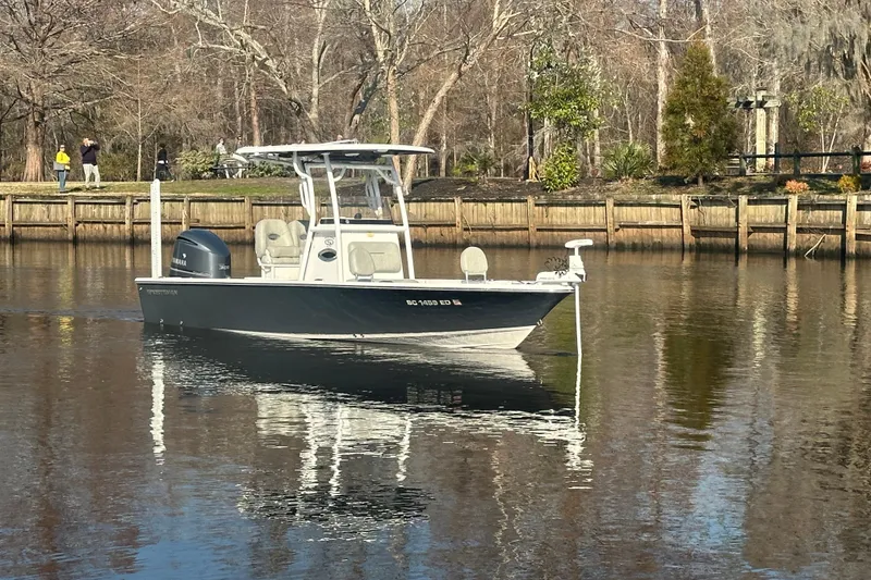 Slide: The Image of 2020 Sportsman Masters 247 Bay Boat on calm river near wooded shoreline. - 6