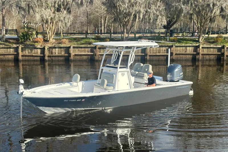 Slide: The Image of 2020 Sportsman Masters 247 Bay Boat on calm water near a wooden dock. - 9