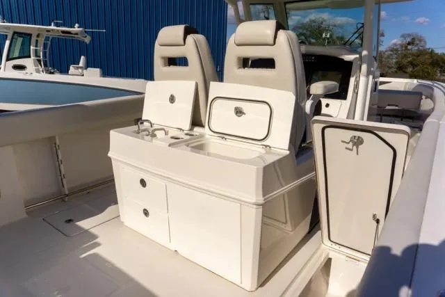 Slide: The Image of 2024 Sailfish 312 CC boat interior with seating and storage compartments. - 15