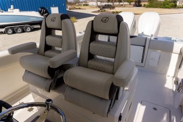 Slide: The Image of 2024 Sailfish 312 CC boat interior with two luxurious captain's chairs. - 18
