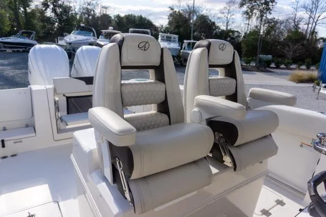 Slide: The Image of 2024 Sailfish 312 CC boat with luxurious seating and dual outboard motors. - 19