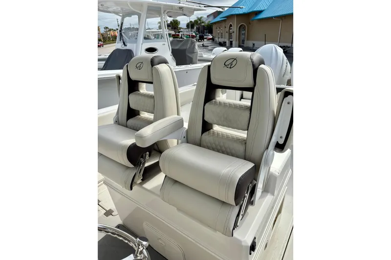 Slide: The Image of 2024 Sailfish 312 CC boat with luxurious dual captain's chairs, featuring elegant design and comfort. - 2