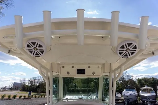 Slide: The Image of 2024 Sailfish 312 CC boat with rod holders and speakers on the T-top. - 20