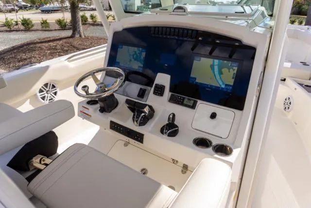 Slide: The Image of 2024 Sailfish 312 CC boat cockpit with modern navigation displays and controls. - 21