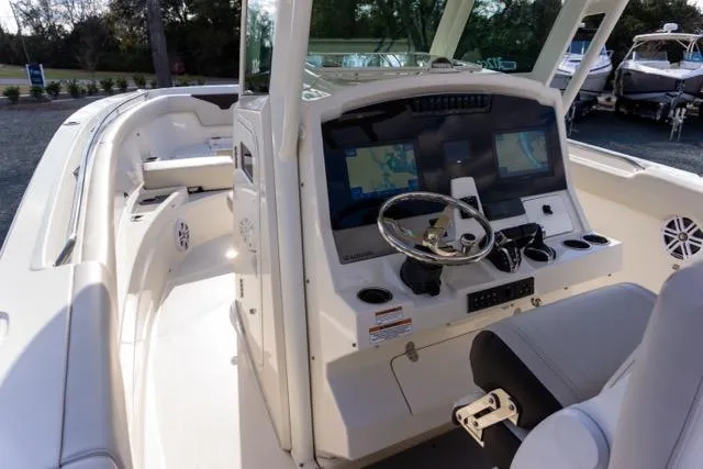 Slide: The Image of 2024 Sailfish 312 CC boat cockpit with modern navigation system and comfortable seating. - 24