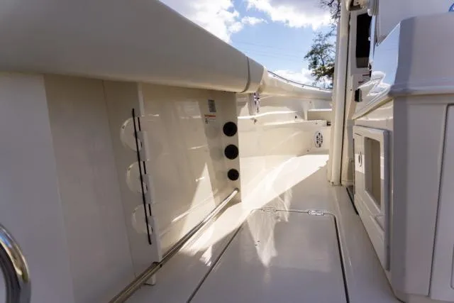 Slide: The Image of 2024 Sailfish 312 CC boat interior with sleek white design and modern features. - 25