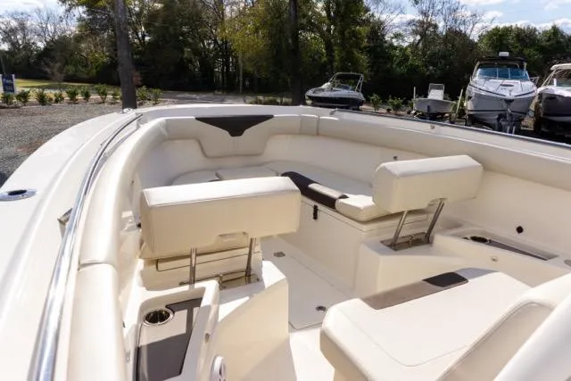 Slide: The Image of 2024 Sailfish 312 CC boat interior with white seating and cup holders. - 26