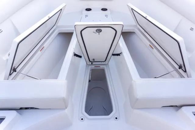 Slide: The Image of 2024 Sailfish 312 CC boat interior with open storage compartments and sleek design. - 29