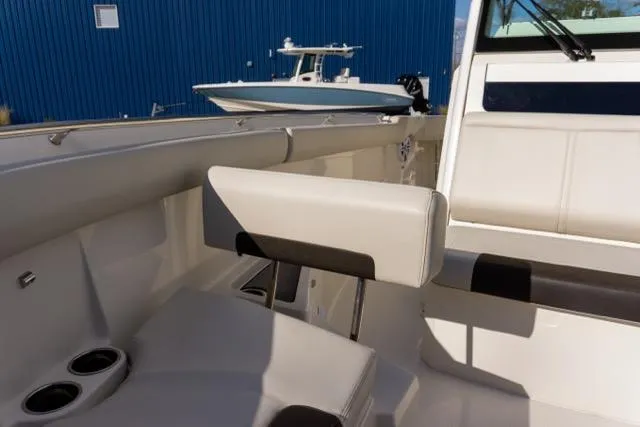 Slide: The Image of 2024 Sailfish 312 CC boat interior with seating and cup holders. - 30