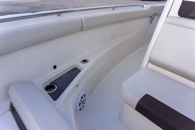 Slide: The Image of 2024 Sailfish 312 CC boat interior with seating, cup holders, and speakers. - 32
