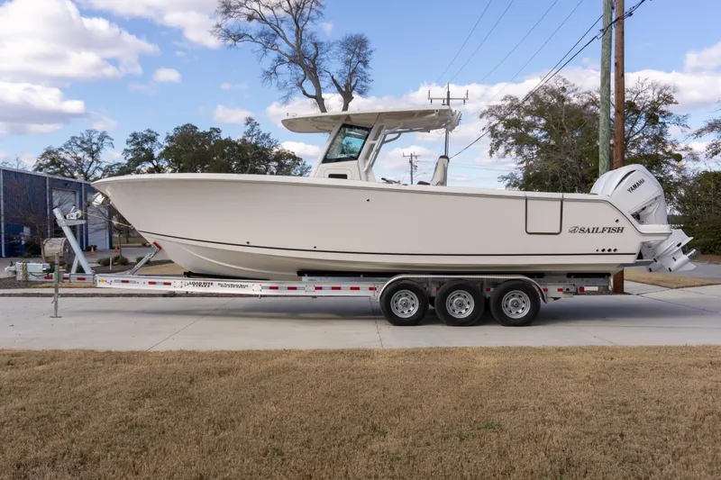 Slide: The Image of 2024 Sailfish 312 CC boat on trailer, side view, outdoors. - 38