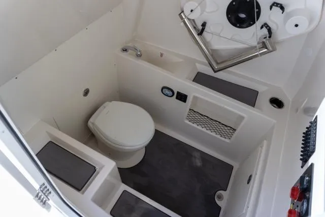 Slide: The Image of 2024 Sailfish 312 CC boat interior with compact bathroom and modern amenities. - 41