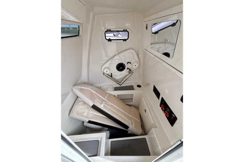 Slide: The Image of 2024 Sailfish 312 CC cabin interior with cushions and storage compartments. - 6