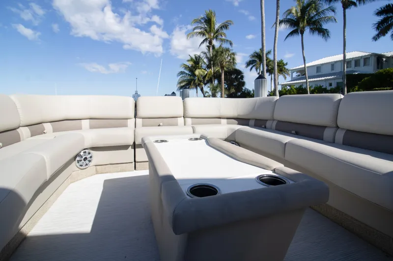 Slide: The Image of Luxurious seating on a 2017 Bennington R 28 RSRX1 pontoon boat under a clear blue sky. - 8