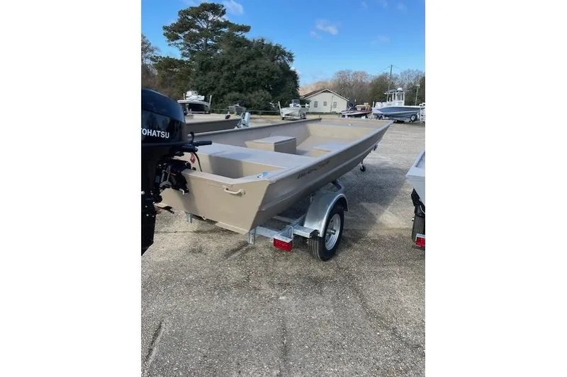 The Image of 2025 Weldcraft 1448 boat on trailer, parked outdoors, with Tohatsu motor. - 0