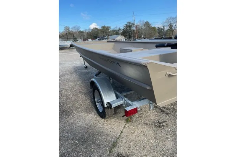 Slide: The Image of 2025 Weldcraft 1448 boat on trailer, parked outdoors on a sunny day. - 3