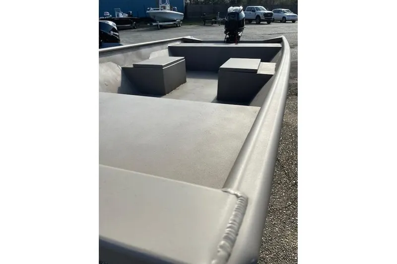 Slide: The Image of 2025 Weldcraft 1448 boat, aluminum interior, parked outdoors with visible motor. - 6