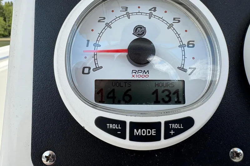 Slide: The Image of Close-up of a 2019 Mako 234 Center Console boat gauge showing 14.6 volts and 131 hours. - 3