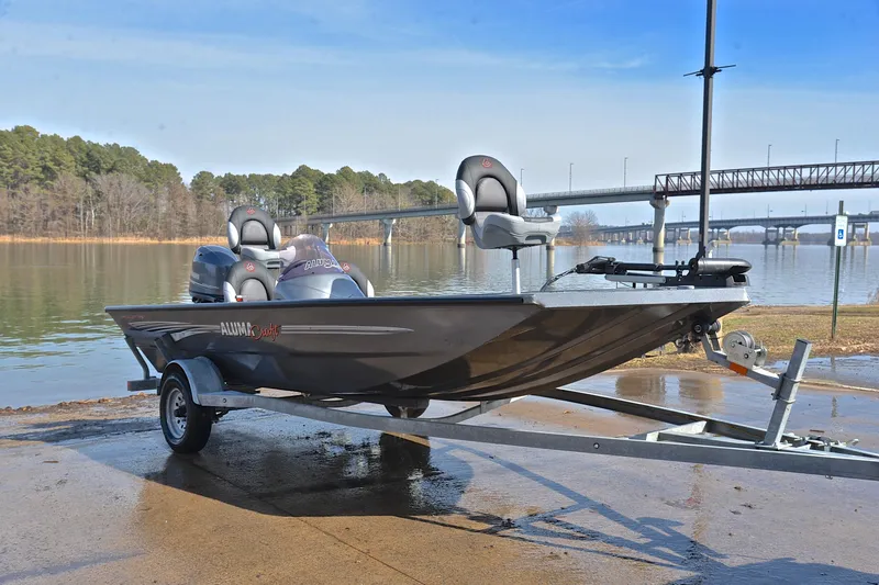 Slide: The Image of 2020 Alumacraft Prowler 175 boat on trailer by a scenic lake. - 16