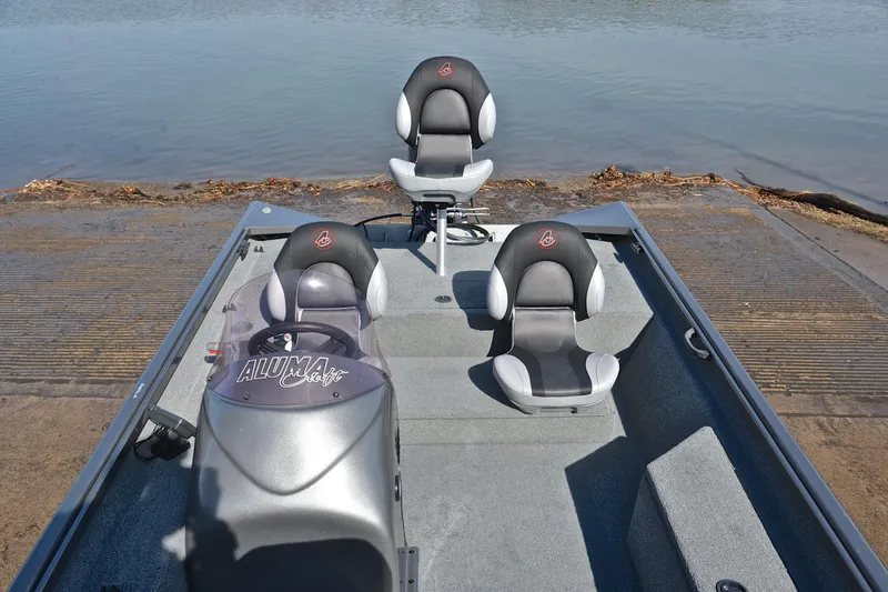 Slide: The Image of 2020 Alumacraft Prowler 175 boat interior with three seats near water. - 21