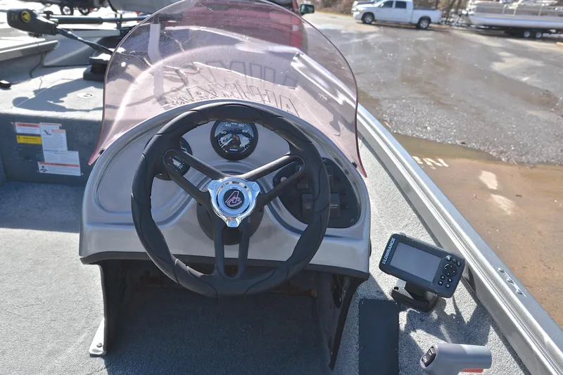 Slide: The Image of 2020 Alumacraft Prowler 175 boat dashboard with steering wheel and navigation equipment. - 24