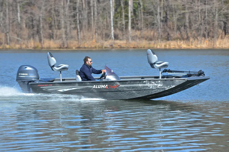 Slide: The Image of 2020 Alumacraft Prowler 175 boat cruising on a calm lake with a Yamaha motor. - 3