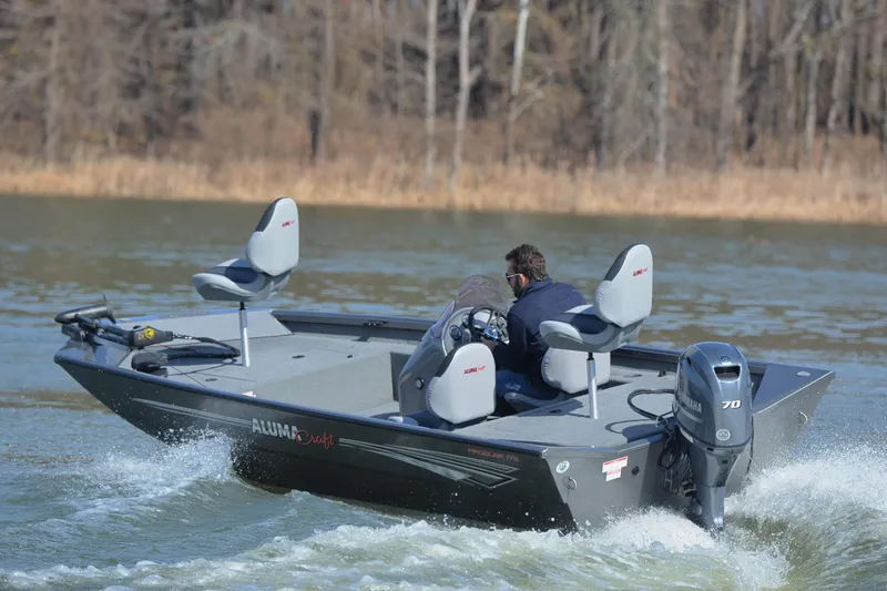 Slide: The Image of 2020 Alumacraft Prowler 175 boat cruising on a lake with three seats and Yamaha motor. - 6