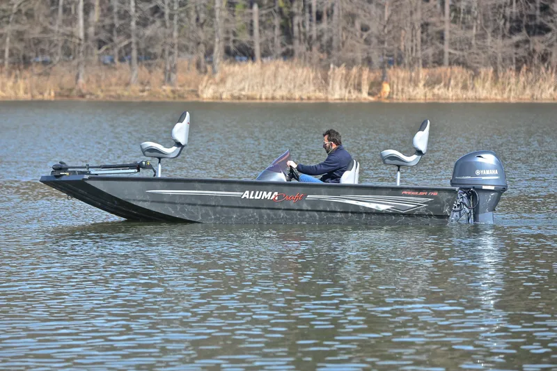 Slide: The Image of 2020 Alumacraft Prowler 175 boat on a calm lake with Yamaha motor. - 9