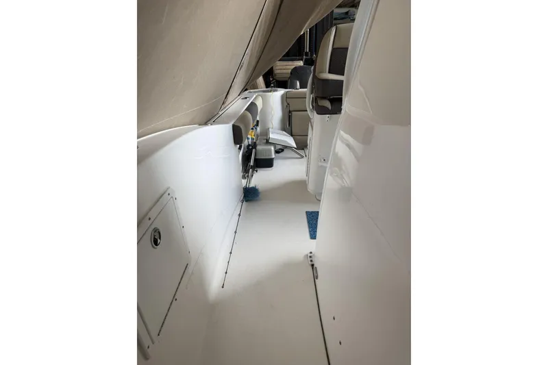 Slide: The Image of 2018 Tidewater 252 CC Adventure boat interior with seating and storage compartments. - 12