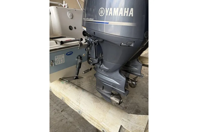 Slide: The Image of 2018 Tidewater 252 CC Adventure with Yamaha outboard motor, docked on a trailer. - 14
