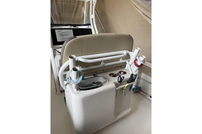 Slide: The Image of 2018 Tidewater 252 CC Adventure boat console with fishing rod holders and Garmin display. - 5