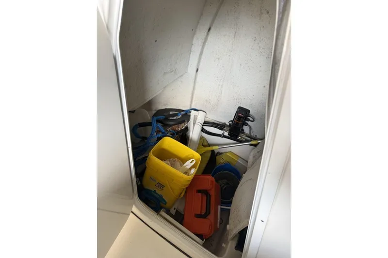 Slide: The Image of Storage compartment of 2018 Tidewater 252 CC Adventure boat with various equipment. - 9