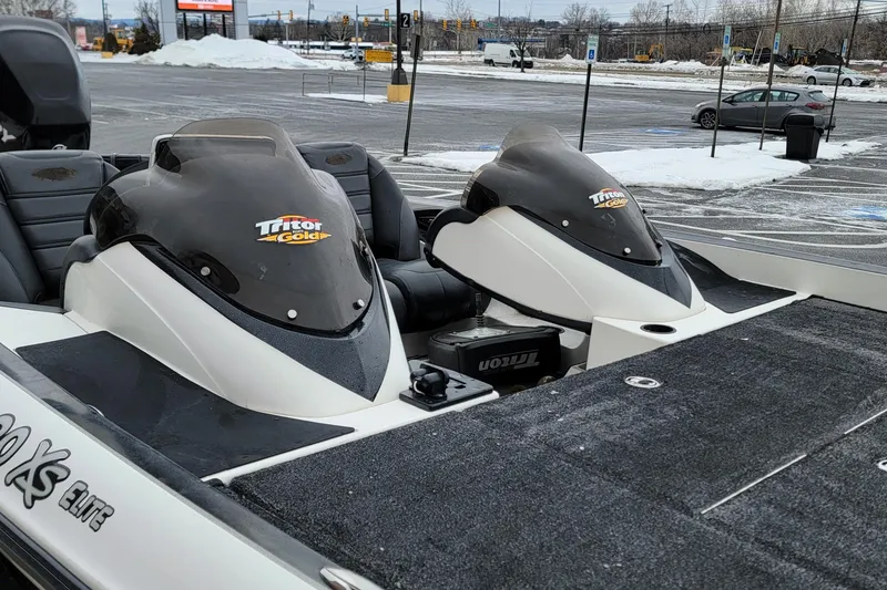 Slide: The Image of 2010 Triton 20XS DC boat in snowy parking lot, showcasing sleek design and branding. - 11