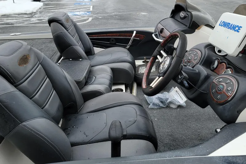 Slide: The Image of 2010 Triton 20XS DC boat interior with leather seats and Lowrance electronics. - 13