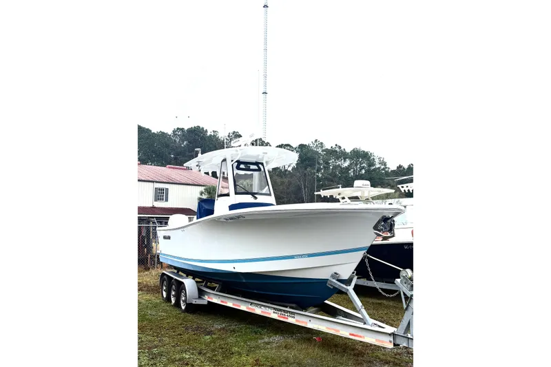 Slide: The Image of 2021 Regulator 28 Forward Seating boat on trailer, parked outdoors. - 11