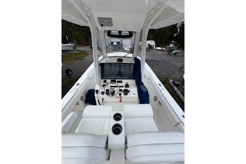 Slide: The Image of 2021 Regulator 28 Forward Seating boat interior with modern helm and white seating. - 5