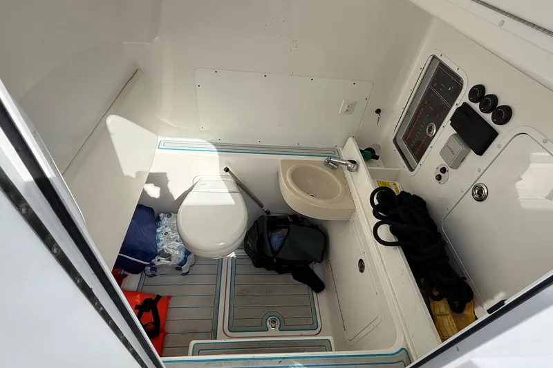 Slide: The Image of 2021 Invincible 36 CC boat interior with toilet, sink, and storage area. - 10