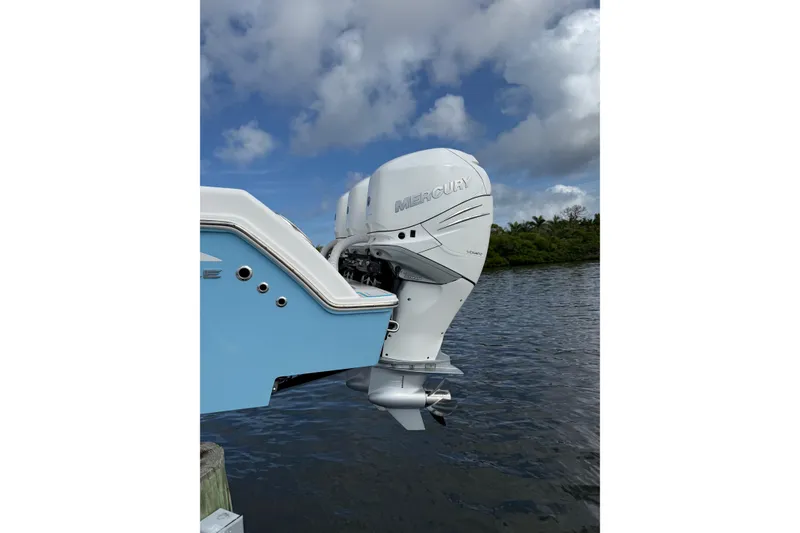 Slide: The Image of 2021 Invincible 36 CC boat with Mercury outboard engine on a calm waterway. - 14